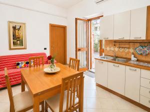 a kitchen and dining room with a wooden table at Casa Are in Oristano
