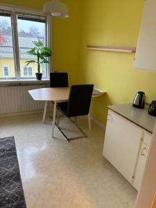 a kitchen with a table and two chairs in a room at Two rooms and kitchen in central Uddevalla in Uddevalla