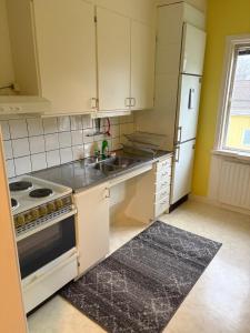 a kitchen with a stove and a white refrigerator at Two rooms and kitchen in central Uddevalla in Uddevalla