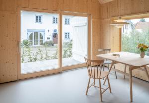 a dining room with a table and a large window at Tiny House Amélie in Bonndorf im Schwarzwald