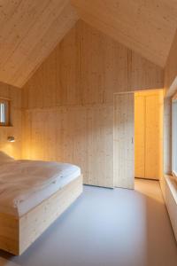 a bedroom with a bed in a wooden room at Tiny House Amélie in Bonndorf im Schwarzwald