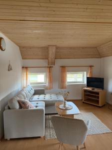 a living room with a couch and a table at Apartment Dehtáře in Dehtáře