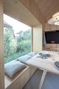 a room with a table and a large window at Tiny House Amélie in Bonndorf im Schwarzwald