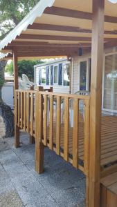 a wooden deck with awning on a house at Mobilhome Rico in Gassin