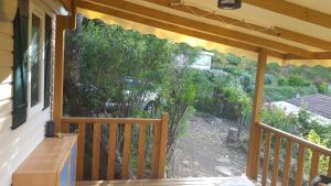 a screened porch with a view of a garden at Mobilhome Rico in Gassin
