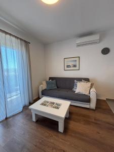 a living room with a couch and a coffee table at Marija in Posedarje +21 photos