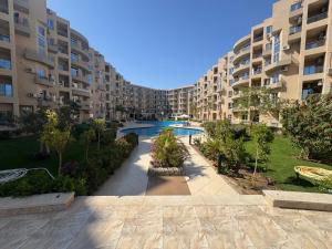 an image of an apartment complex with a swimming pool at Luxury Smart Home- Villa Duplex in Hurghada