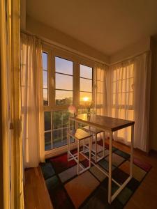 a table and chair in a room with a window at EL BALCON DE LUARCA in Luarca