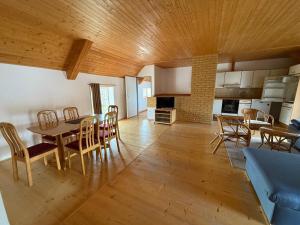 a kitchen and dining room with a table and chairs at Apartment Dehtáře in Dehtáře