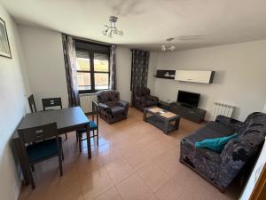 a living room with a couch and a table at SEGEDA 3 APARTAMENTOS Turísticos in Calatayud