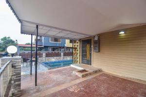 a house with a swimming pool and a patio at Klassone Bunglow in Khandāla