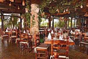 a restaurant with wooden tables and chairs and vines at Ocean Paradise View in Adeje