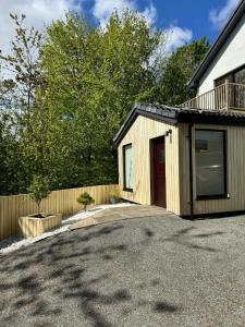 a house with a garage and a fence at 1 Manse Lane in Portree