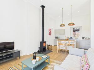 a living room with a couch and a stove at Laura's House in Coupar Angus