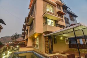 a building with a pool in front of it at Klassone Bunglow in Khandāla