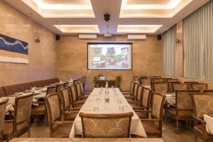 a row of tables and chairs in a restaurant at Hotel Rock Regency Mount Abu - A Boutique Rodetel in Mount Ābu