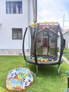 a swing set with balls in a yard at Apartman 23 in Kraljevo