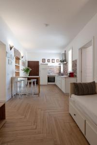 a living room with a kitchen and a dining room at Gold Apartment in Ferrara