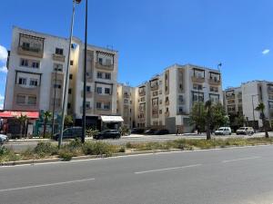 an empty street in a city with tall buildings at Apparemment TAMARIS in Dar Bouazza