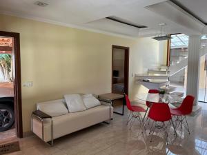 a living room with a couch and a table at Chácara com Piscina in Poços de Caldas