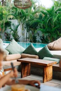 a living room with a couch and a coffee table at Global Surf Lodge Kabalana in Ahangama