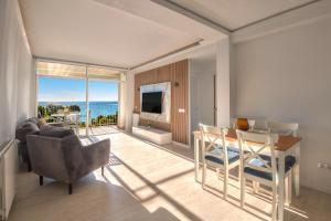 a living room with a view of the ocean at Seafront apartment in Platja d'Aro with parking in Platja d'Aro