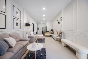 a living room with a couch and a table at Arun Sa Wad - Chinatown House in Bangkok
