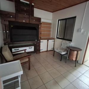 a living room with a large flat screen tv at Vir Oulaas Guesthouse in Nieuwoudtville