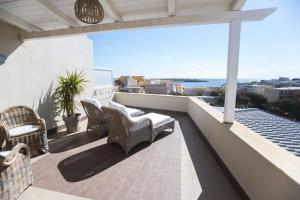 a balcony with chairs and a view of the ocean at Hotel Sole in Lampedusa