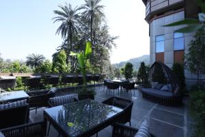a patio at a hotel with tables and chairs at Hotel Rock Regency Mount Abu - A Boutique Rodetel in Mount Ābu