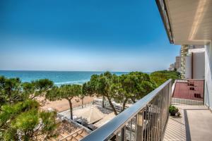 a balcony with a view of the beach at Seafront apartment in Platja d'Aro with parking in Platja d'Aro +6 photos
