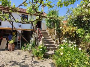a set of stairs leading up to a house at Bota Rota Pilgrim House in Paredes de Coura