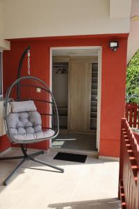 a swing on the front porch of a house at Apartment Alana in Podvelka