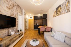 a living room with a couch and a table at Liman 5 Riverside 209 i 109 with Free Private Parking in Novi Sad