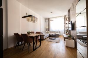 a living room with a table and a couch at Liman 5 Riverside 209 i 109 with Free Private Parking in Novi Sad