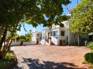 a large white house with a driveway at Berg and Dal in Paarl