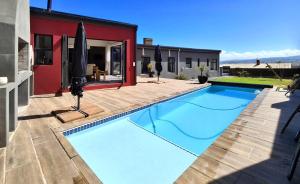 a swimming pool in the backyard of a house at Getaway between the sea and the mountains in Gordonʼs Bay
