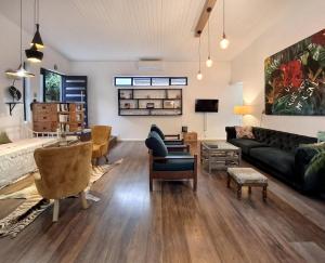 a living room with a couch and a table at Getaway between the sea and the mountains in Gordonʼs Bay