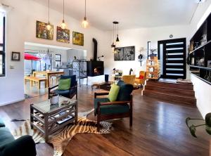 a living room with a couch and a table at Getaway between the sea and the mountains in Gordonʼs Bay