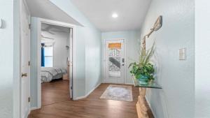 a hallway with a door leading to a bedroom at By The Lake Resort Access in Lake Ozark