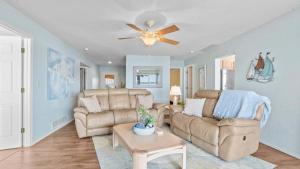 a living room with a couch and a ceiling fan at By The Lake Resort Access in Lake Ozark +35 photos