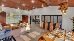 a living room with a table and a couch at SaffronStays Ivy Courtyard - 5 bedroom & Veg Only Villa in Khopoli in Jambhulpāda +48 photos