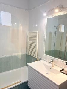 a bathroom with a sink and a mirror and a tub at Golden Vedra Residences in Pontevedra +28 photos
