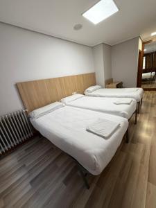 a row of beds in a room at Bearan Rooms 2 in Pamplona