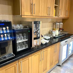 a kitchen with a counter with a coffee maker at Hotel 63 in London