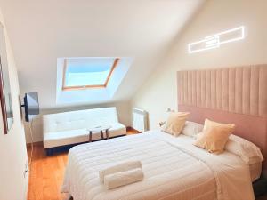 a bedroom with a large bed and a window at Golden Vedra Residences in Pontevedra