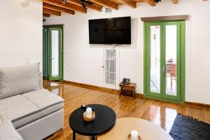 a living room with a couch and a table at Casa Di Nonno-Jacuzzi Mountain View Stay in Lesvos in Agiásos