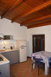 a kitchen with a table and a bed in a room at Il Loft Arona Centro, Le Dimore del Corso in Arona