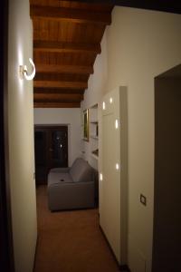 a living room with a couch in a room at Il Loft Arona Centro, Le Dimore del Corso in Arona