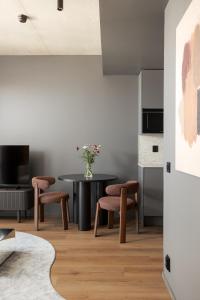 a dining room with a table and two chairs at Aarni Property in Jyväskylä